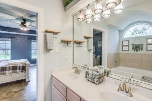 a bathroom with two sinks and a tub and a mirror at 5 Mi to Belton Lake Peaceful Home with Hot Tub in Belton +25 photos