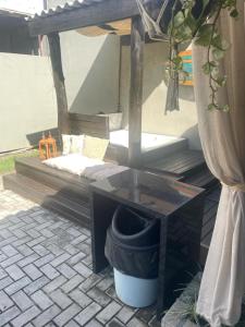 a bed sitting under a canopy with a bucket at Casas Bravo in Itajaí