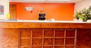 a bar in a room with an orange wall at Mountain Inn in Iron Mountain