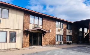 a brick building with the front door open at Mountain Inn in Iron Mountain