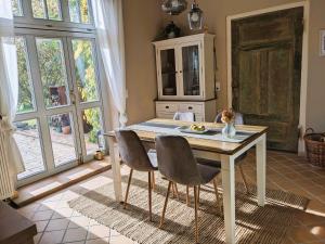 a kitchen with a table and two chairs at Ferienhaus Salvia in Gremersdorf