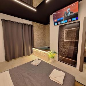 a room with a tv and a large fireplace at Dark & Light rooms & luxury suites in Catania