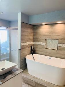 ein Badezimmer mit einer weißen Badewanne und einem Waschbecken in der Unterkunft 13839 sheri hollow ln in Houston