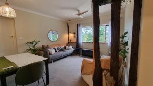 a living room with a couch and a table at Kashikiri- Adelaide Hills Private Japanese Bath Retreat- pre-finished special in Crafers