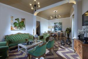 a living room with green furniture and a table at Erato Vintage House (city center) in Heraklio Town