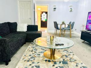 a living room with a couch and a glass table at The Esplanade Lodge-Free Parking in Strood