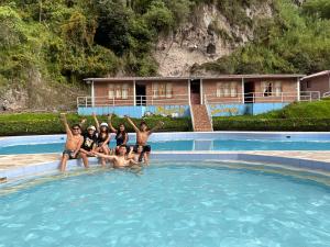a group of people standing in a swimming pool at Playita Salomon in Baños