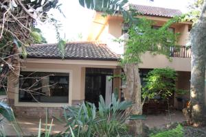 a house with a patio in front of it at 14 Zimbali Chalets in Ballito