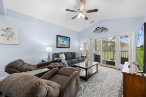 a living room with a couch and a ceiling fan at Gorgeous 3BR 3BA Villa W/Amazing Views Near Beach in Myrtle Beach