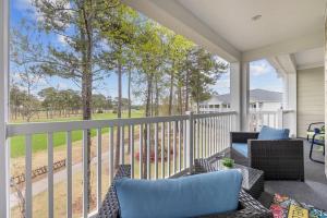 a porch with a couch and chairs on a balcony at Gorgeous 3BR 3BA Villa W/Amazing Views Near Beach in Myrtle Beach