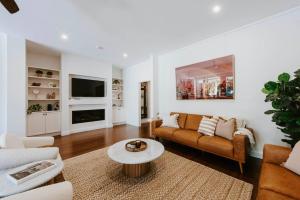 a living room with a couch and a table at 'Haylock' Luxe Country Charm in Mudgee's Centre in Mudgee