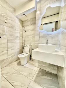 a bathroom with a toilet and a sink and a mirror at Arte Cheras, Kuala Lumpur 3 Room x 8 pax KLCC Nice View Karaoke with BathTub in Kuala Lumpur