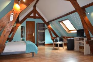 a bedroom with a bed in a room with wooden beams at Le Domaine des Cigognes in Ennevelin