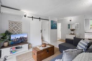 a living room with a cat sitting on a table at Inner City apartment living in quiet location in Brisbane