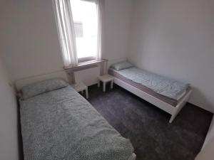 a bedroom with two beds and a window at 2 Room Apartment 15min to Fair in Hannover