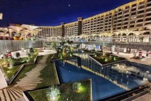 a hotel with a pool in front of a building at Unique duplex hotel apartment pool view in Cairo