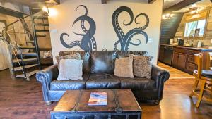 a leather couch in a living room with a table at Shorebirds Villas in Ocean Shores