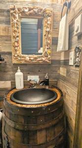 a bathroom with a barrel sink and a mirror at Shorebirds Villas in Ocean Shores