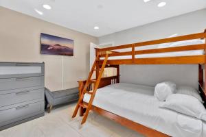 a bedroom with a bunk bed and a desk at New cheerful villa, Pool, Spa, Mini Golf, Game room, Fire pit next to Disneyland in Anaheim +53 photos