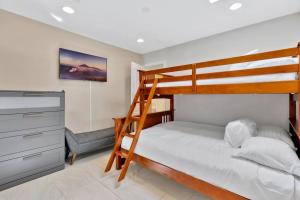a bedroom with a bunk bed and a desk at New cheerful villa, Pool, Spa, Mini Golf, Game room, Fire pit next to Disneyland in Anaheim