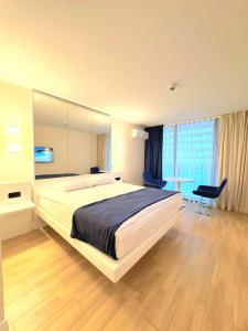 a large bedroom with a large bed and a table at ORBI CITY batumi in Batumi