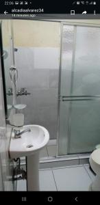 a bathroom with a sink and a glass shower at July in San Felipe de Puerto Plata