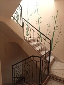 a staircase with a painting of bamboo on the wall at Maison du Fleurs in Taroudant
