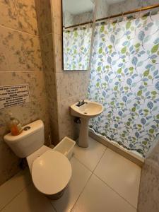 a bathroom with a toilet and a sink at La Casa de Pia in Baños
