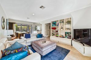 a living room with white furniture and a tv at Family Comfort - Walk to Beaches, Train and Coffee in Fremantle