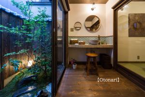 a bathroom with a fish tank and a mirror at Kyoisuke in Kyoto
