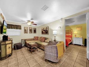 a living room with a couch and a bed at Paradise Cove at Island Getaway in Bradenton Beach