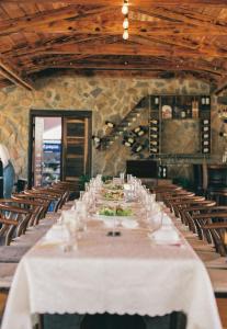 a long dining room with a white table and chairs at Kim Ngan Hills Resort Da Lat. in Da Thien