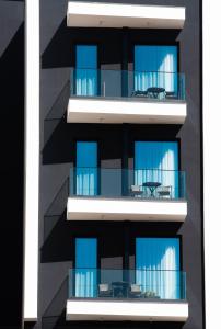 an apartment building with blue balconies at La Onda Hotel Durres in Durrës