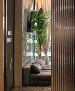 a living room with a couch and a window at La Onda Hotel Durres in Durrës