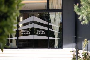 a window of a hotel la guardia at La Onda Hotel Durres in Durrës