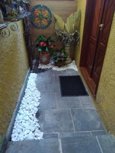 a walkway with rocks and a door at Bromélia Sabiá & Cia in Teresópolis