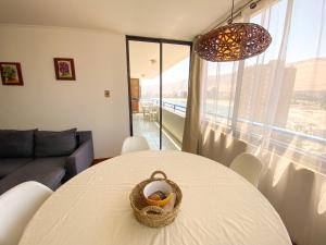 a living room with a table with a basket on it at Edificio Royal Marine in Iquique