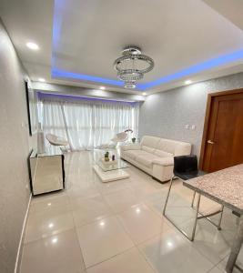 a living room with a couch and a table at beautiful penthouse Santo Domingo in Santo Domingo