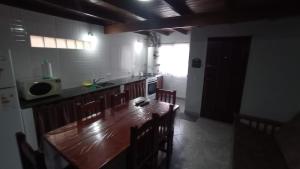 a kitchen with a long wooden table and chairs at Del muelle in Miramar