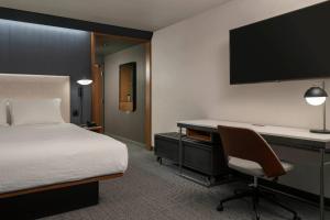 a bedroom with a bed and a desk with a computer at Courtyard by Marriott Nashville Smyrna in Smyrna