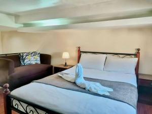 a bedroom with a bed with a towel on it at Pal-Watson Apartments in Mactan