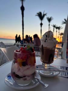 a cup of ice cream and a drink on a table at A spacious and cozy apartment. in Torrevieja +8 photos
