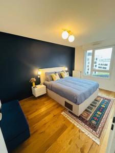 - une chambre avec un grand lit et une grande fenêtre dans l'établissement Sublime Appartement Proche JO 2024, à Saint-Denis