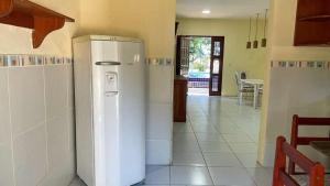 a kitchen with a white refrigerator in a room at Chácara Sitio Icaraí Caucaia-CE in Caucaia