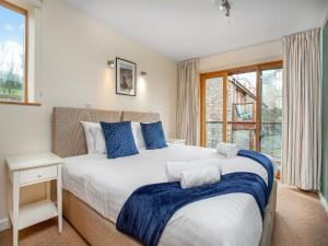 a bedroom with a large bed and a window at Curlew in Hemborough Post