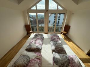 a large room with two beds in front of a large window at Ferienhaus Bergblick in Tettnang