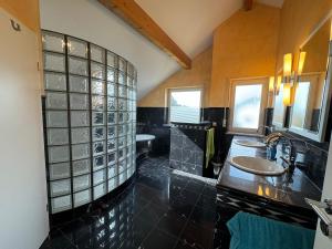 a large bathroom with a sink and a shower at Ferienhaus Bergblick in Tettnang +45 photos