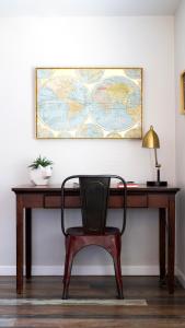 a desk with a chair and a map on the wall at Cozy Stylish Home in the Heart of JT Village in Joshua Tree