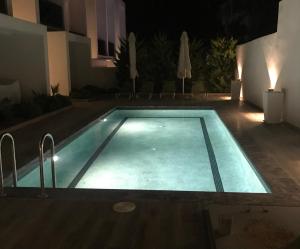 basen w nocy obok budynku w obiekcie Kallithea love paradise pool & garden w mieście Kallithea