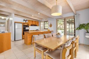 a kitchen and dining room with a wooden table and chairs at Hot Springs Landing Pad in Rye